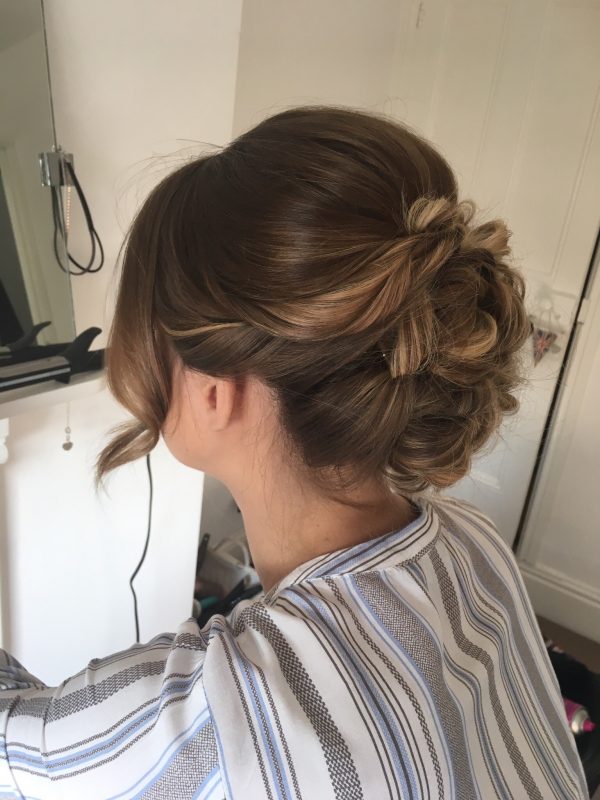 A female showcases the her wedding hair style from behind