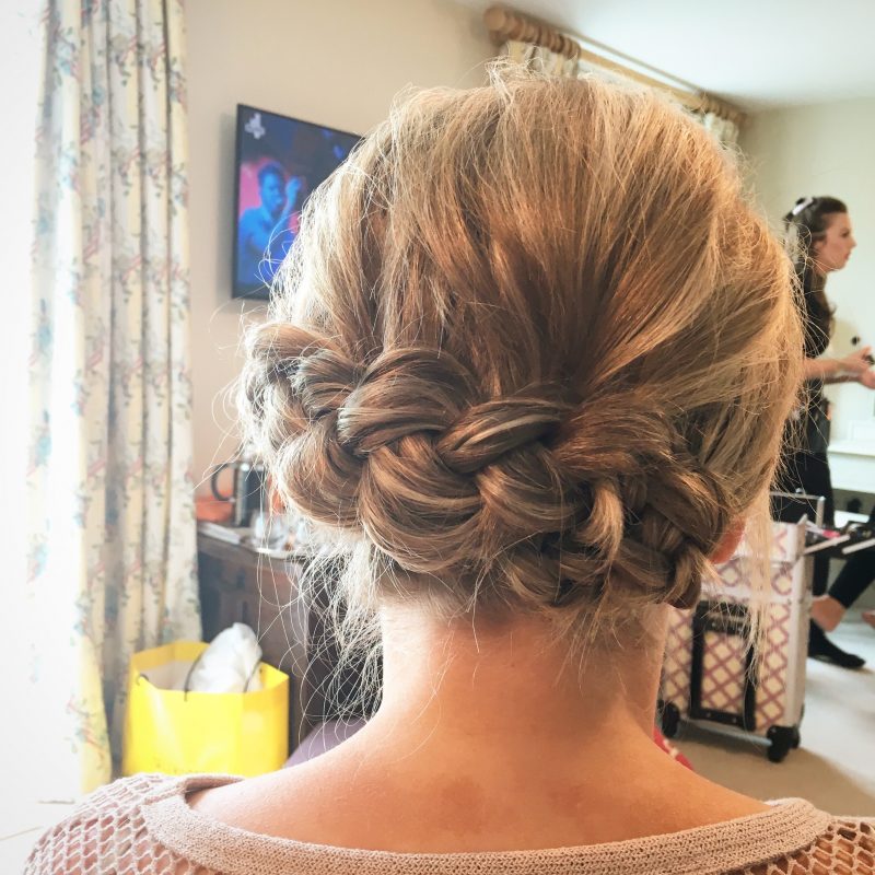 A female showcases the her wedding hair style from behind