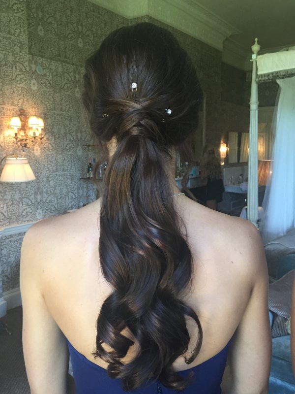 a bride showcases her wedding hair