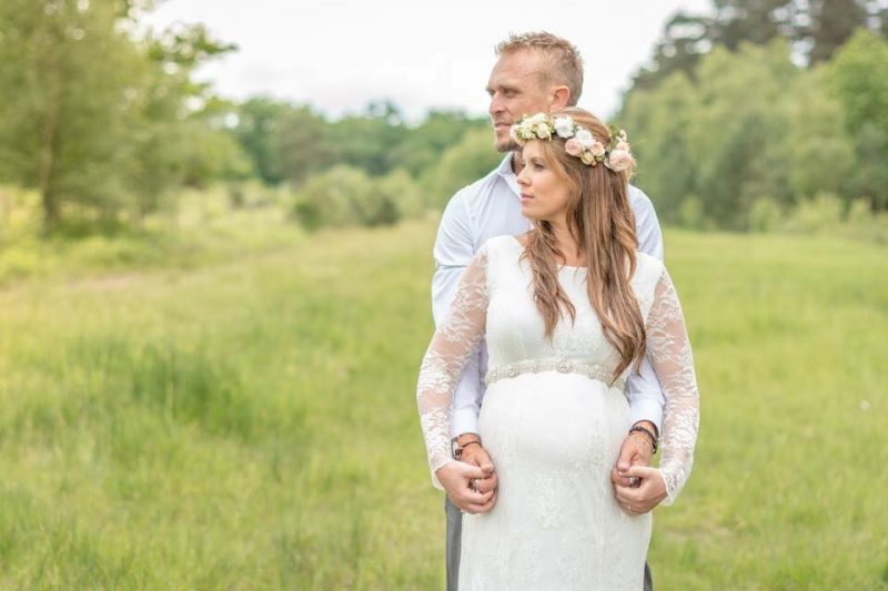 London bride in hair and makeup outside with groom.