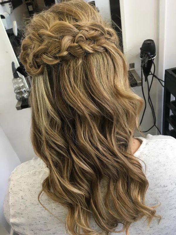 A female showcases the her wedding hair style from behind