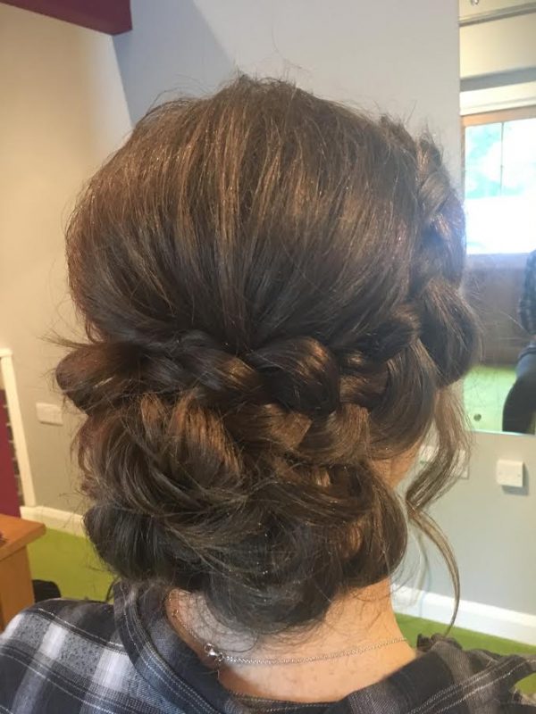 A female showcases the her wedding hair style from behind